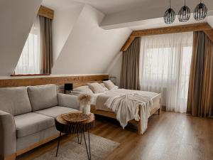a bedroom with a bed and a couch at Willa Bliźniaczek in Zakopane