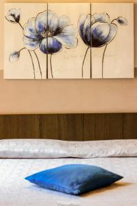 a blue pillow sitting on top of a table at Albergo Florida Taggia in Taggia