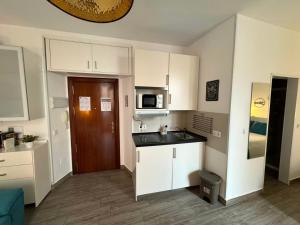 a small kitchen with a sink and a microwave at Sol de Málaga in Málaga