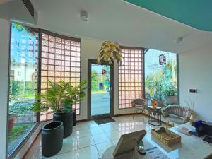 a living room with large windows and plants in it at Doge Veneziano in Mestre