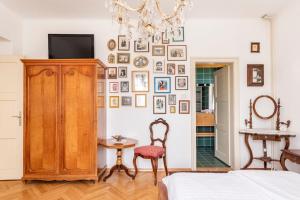 a bedroom with a bed and a wall of pictures at Spacious And Historic Villa With Bled Castle View in Bled