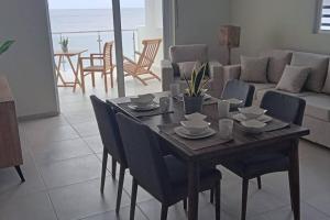 a dining room table and chairs in a living room at Blue Lagun Apartment B in Willemstad