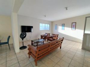 a living room with chairs and a flat screen tv at APtº 1º andar em Olinda Casa Caiada a 100 mts da praia in Olinda