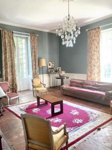 a living room with a couch and a table at Villa de 10 chambres avec vue sur la ville piscine privee et jardin amenage a Villeneuve sur Lot in Villeneuve-sur-Lot