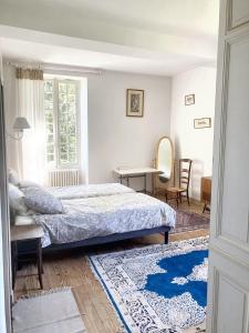 a bedroom with a bed and a table and chairs at Villa de 10 chambres avec vue sur la ville piscine privee et jardin amenage a Villeneuve sur Lot in Villeneuve-sur-Lot
