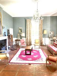 a living room with a couch and a rug at Villa de 10 chambres avec vue sur la ville piscine privee et jardin amenage a Villeneuve sur Lot in Villeneuve-sur-Lot