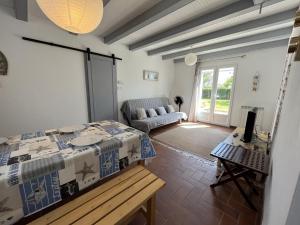 uma sala de estar com uma mesa e um sofá em maison 4 personnes a Sion sur L ocean em Les Bussolleries