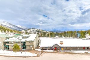 a resort in the mountains with snow on the roofs at Whitefish Mountain Condo - Ski Resort On-Site! in Whitefish