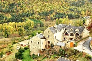 an aerial view of a large stone house at Maison pittoresque à Mostuéjouls avec vue sur la montagne in Mostuéjouls