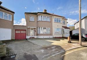 a large brick house with a red garage at Barking London House sleeps 12 - parking - train tube - airport in London