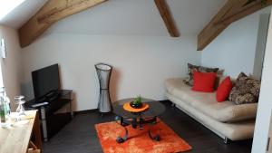 a living room with a couch and a table at Le Relais du Château Monney in Cournillens