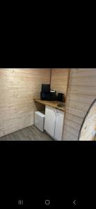 a small kitchen with a counter and a stove at New hotub glamping pods in Kinlet