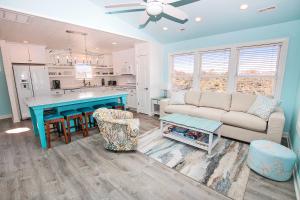 a living room with a couch and a table at NH300, Driftwood Dreams- Oceanside, Near shopping, Close to Ocean! in Nags Head