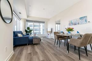 a living room with a blue couch and a table at Upscale 1BR Condo with King Bed and Amazing Cityscape Views in Kitchener