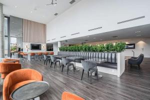 a restaurant with tables and chairs and plants at Upscale 1BR Condo with King Bed and Amazing Cityscape Views in Kitchener