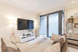 a living room with a couch and a tv at The Iveagh Suite - IFSC Dublin 1 in Dublin