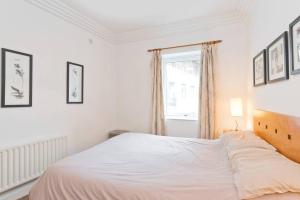 1 dormitorio con cama blanca y ventana en The Mayor Suite - IFSC Dublin 1, en Dublín