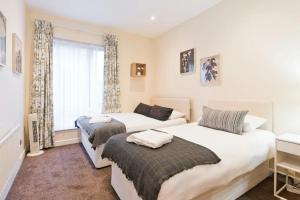 a bedroom with two beds and a window at The Iveagh Suite - IFSC Dublin 1 in Dublin