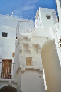 a white building with stairs on the side of it at Casa Mario in Cisternino