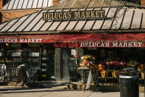 a store with a red awning on a street at No. 284 powered by Sonder in Boston