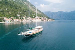 a boat floating on a large body of water at Traditional Sailing Yacht in Tivat