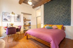 a bedroom with a bed and a table and a desk at Ardiglione Flat in Florence