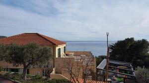 a house with a view of the ocean at Agriturismo La Realidad in Finale Ligure