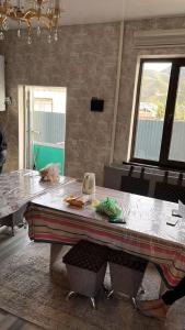 a table in a kitchen with a counter top at Дастан гостевой дом in Naryn