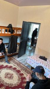 a group of people in a room with a mirror at Дастан гостевой дом in Naryn +10 photos
