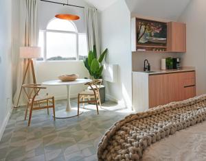 a living room with a bed and a table at Cobalt Coast Resort in West Bay