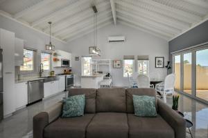 a living room with a couch and a kitchen at Tierra Del Sol Resort & Golf in Palm-Eagle Beach