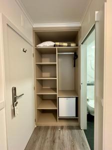 a walk in closet with a door and shelves at Casa do Paço in Termas de Sao Pedro do Sul +50 photos