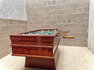 a chess board in a room with a brick wall at Casa de Madera y Mármol in Ambato