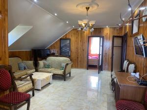 a living room with chairs and a couch and a table at Homestay in Batumi Дом в Чакви in Chakvi