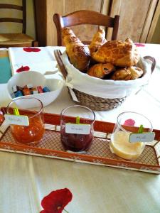 a tray of food on a table with a basket of pastries at Chambres pour évènements sur circuit LE MANS et JO PARIS 2024 in Rouillon