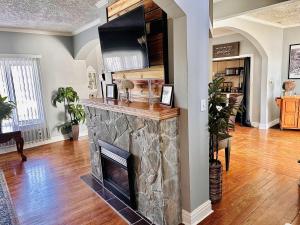 a living room with a stone fireplace at Speedway Legacy Inn in Indianapolis