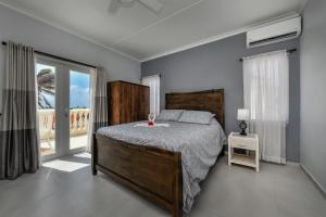 a bedroom with a bed and a large window at Tierra Del Sol Resort & Golf in Palm-Eagle Beach