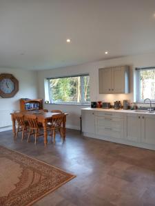 a kitchen and dining room with a table and chairs at The Bungalow, Forest of Dean in Coleford