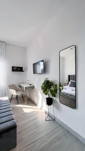 a living room with a mirror and a bed at Dream & Relax in San Donato Milanese