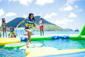 a group of children playing on a raft in the water at Bay Gardens Inn in Gros Islet