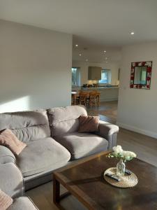 a living room with a couch and a coffee table at The Bungalow in Coleford