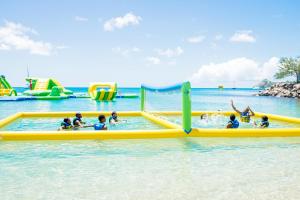 a group of people playing in the water at a water park at Bay Gardens Inn in Gros Islet