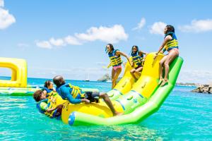 a group of people riding on a raft in the water at Bay Gardens Inn in Gros Islet