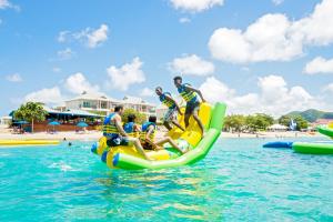 a group of people riding on a raft in the water at Bay Gardens Inn in Gros Islet