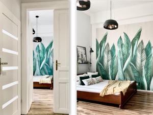 a bedroom with a mural of leaves at GREEN APARTMENTS #Nowy Square, Kazimierz district in Kraków