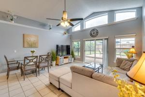 a living room with a couch and a table at Lovely Florida Retreat with Lanai 5 Mi to Riverwalk in Lake Mary