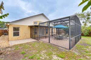 a large glass extension of a house with a patio at Lovely Florida Retreat with Lanai 5 Mi to Riverwalk in Lake Mary