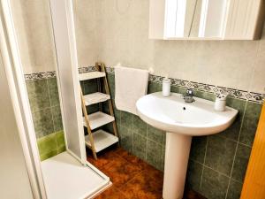 a bathroom with a sink and a shower at El Balcón de Zuheros in Zuheros