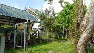 a garden with trees and a house at Goose House in Yung-an-ts'un