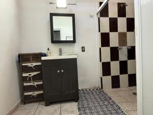 a bathroom with a sink and a mirror at Casa Katrina #2 in Sayulita